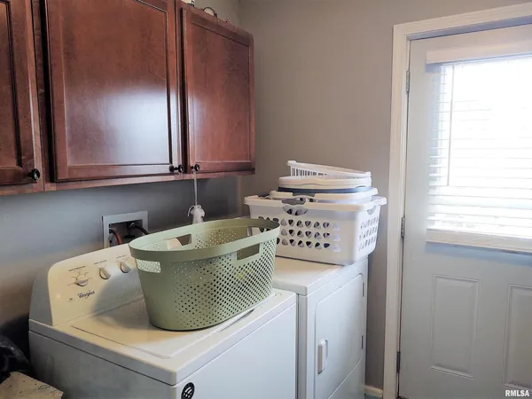 a kitchen with a stove a washer and dryer
