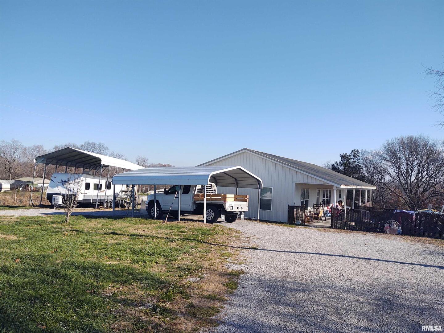 1470 Old Bloomfield Road Vienna, IL 62995 - Photo 2 of 25 a front view of a house with a yard garden and outdoor seating