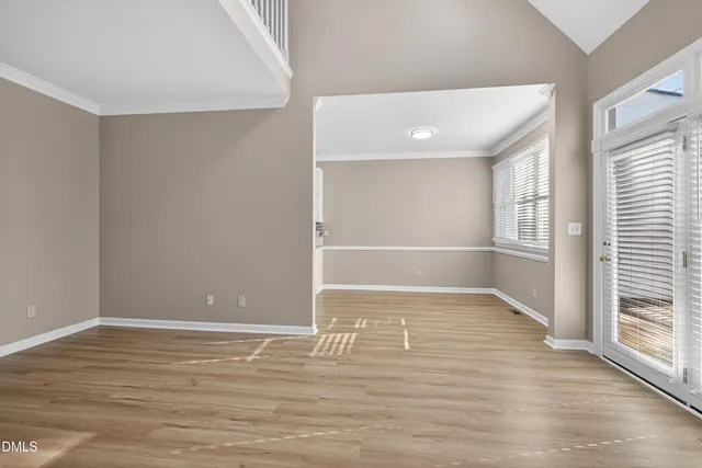 an empty room with windows and closet