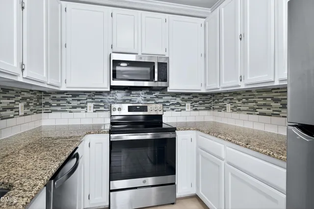 a view of a hallway with wooden floor and entryway