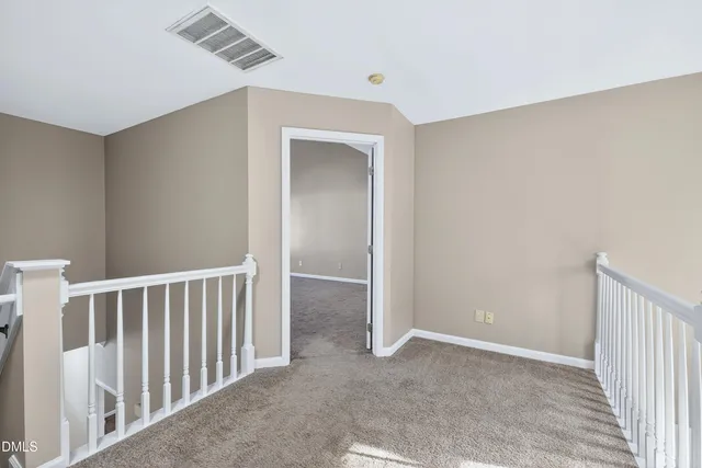 an empty room with closet and a ceiling fan