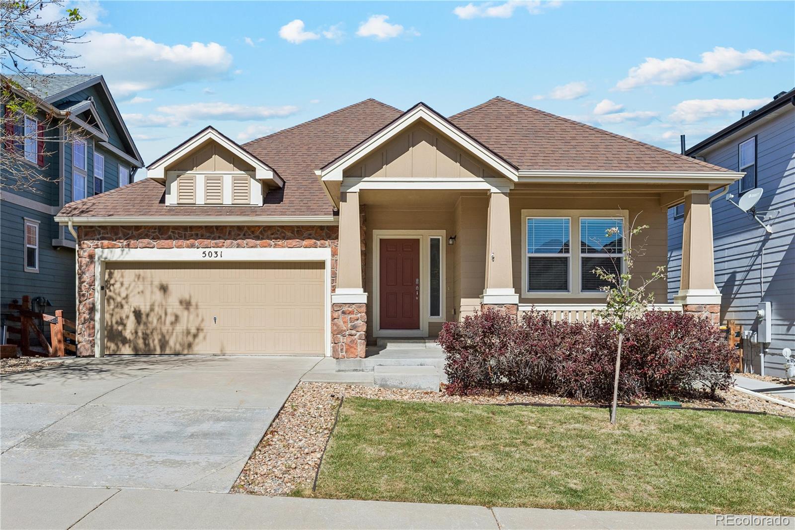 5031 South Rome Street Aurora, CO 80015 - Photo 1 of 39 a front view of a house with garden