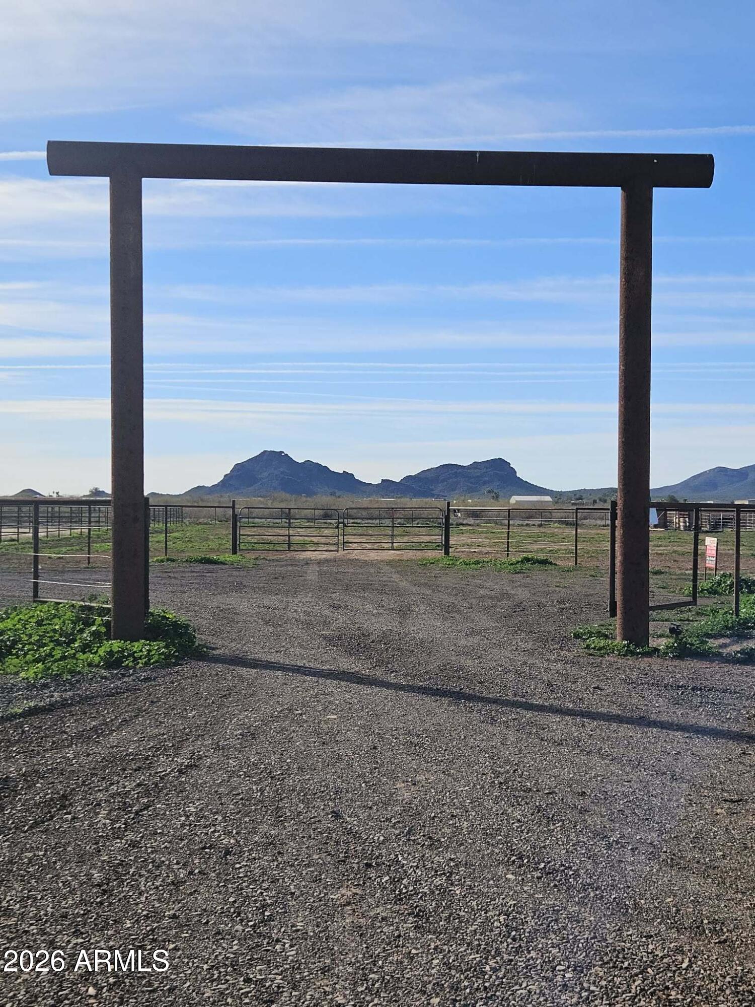 51252 West Buffalo Dog Road Aguila, AZ 85320 - Photo 2 of 27 a view of a road with a large barn in the background