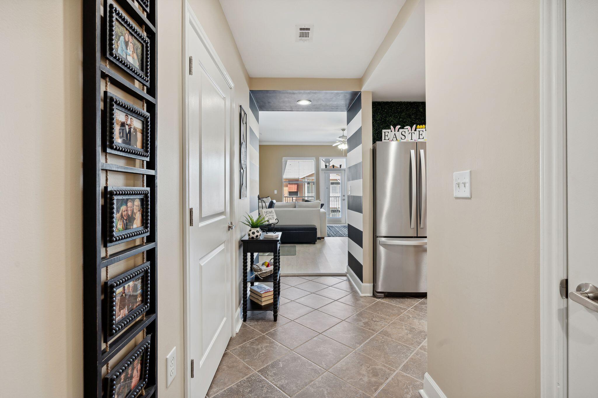 8700 Front Beach Road, Unit 6310 Panama City Beach, FL 32407 - Photo 1 of 42 a kitchen with refrigerator and table