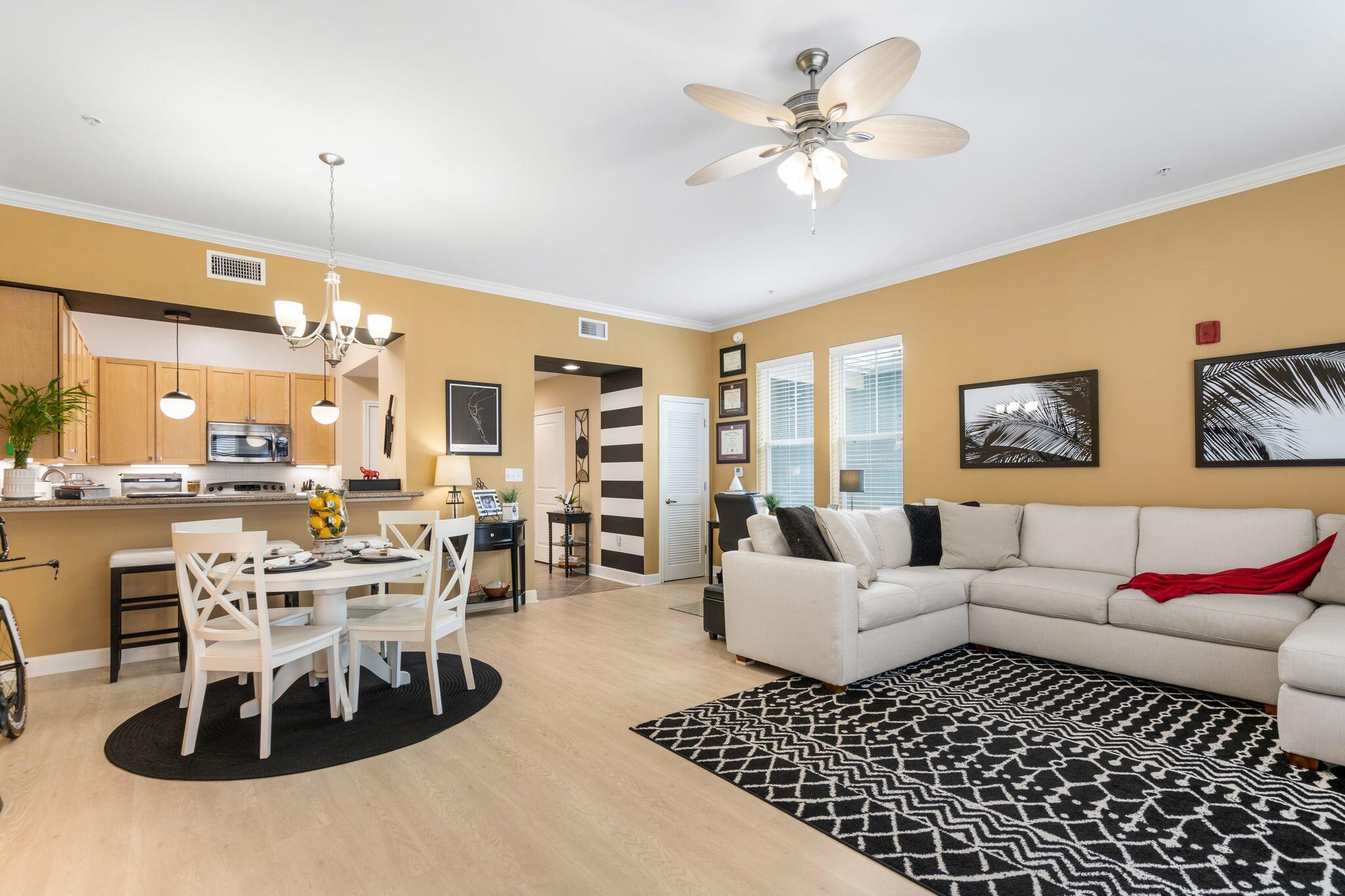 8700 Front Beach Road, Unit 6310 Panama City Beach, FL 32407 - Photo 14 of 42 a living room with furniture a rug and a chandelier