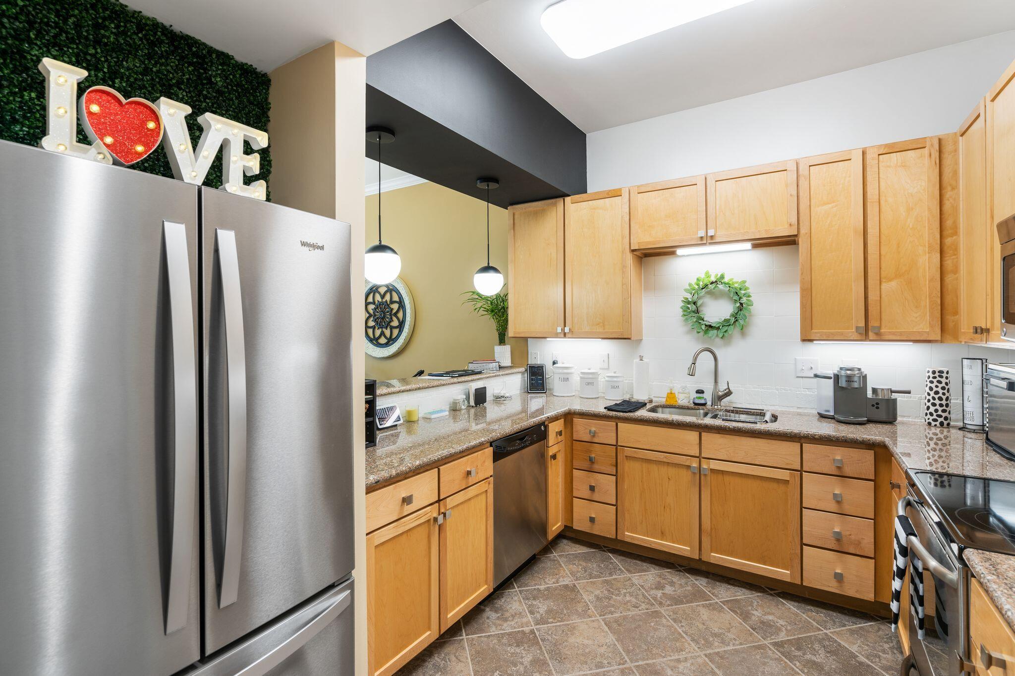 8700 Front Beach Road, Unit 6310 Panama City Beach, FL 32407 - Photo 2 of 42 a kitchen with stainless steel appliances granite countertop a refrigerator and a sink