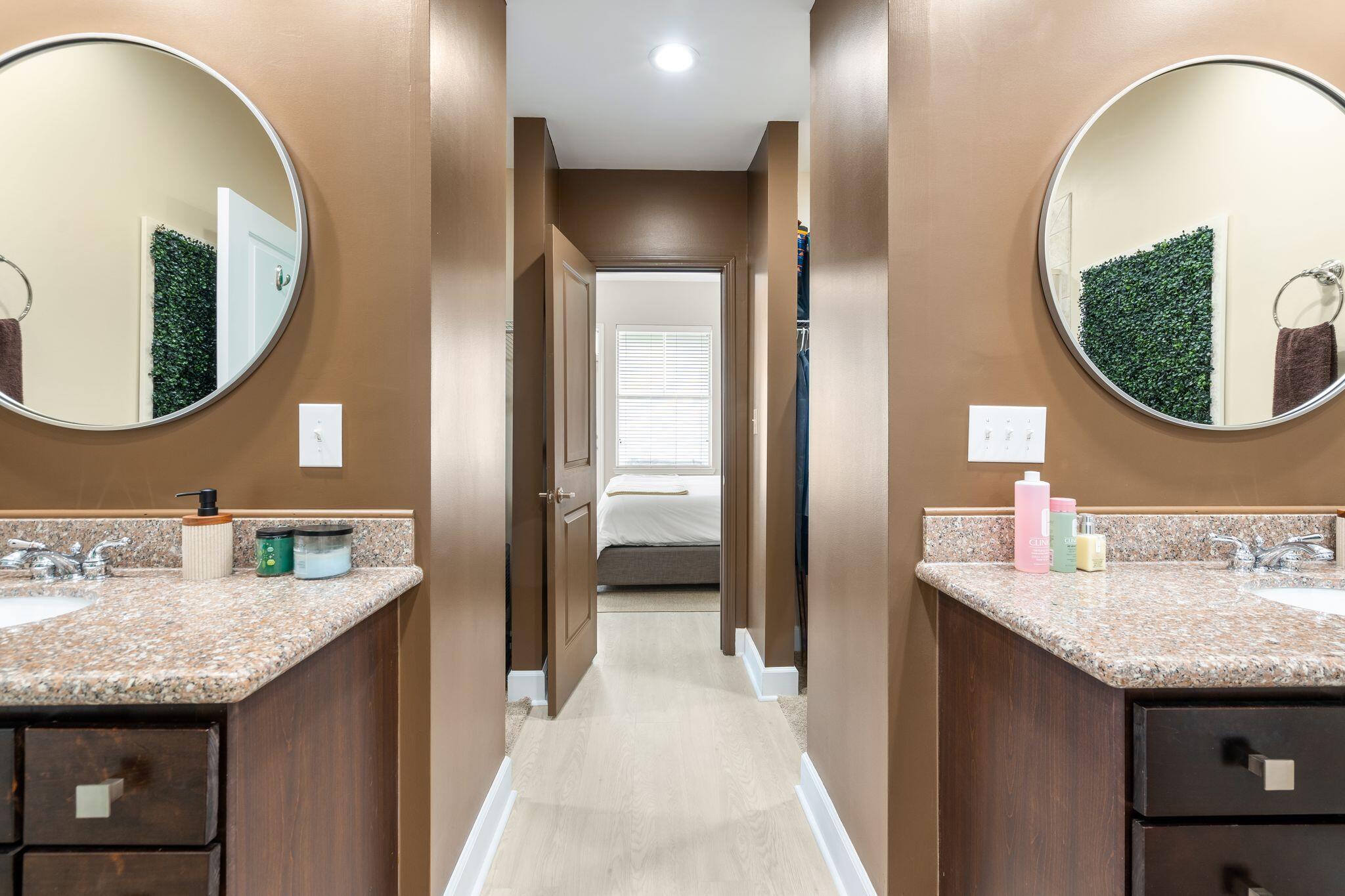 8700 Front Beach Road, Unit 6310 Panama City Beach, FL 32407 - Photo 25 of 42 a bathroom with a granite countertop sink and a mirror