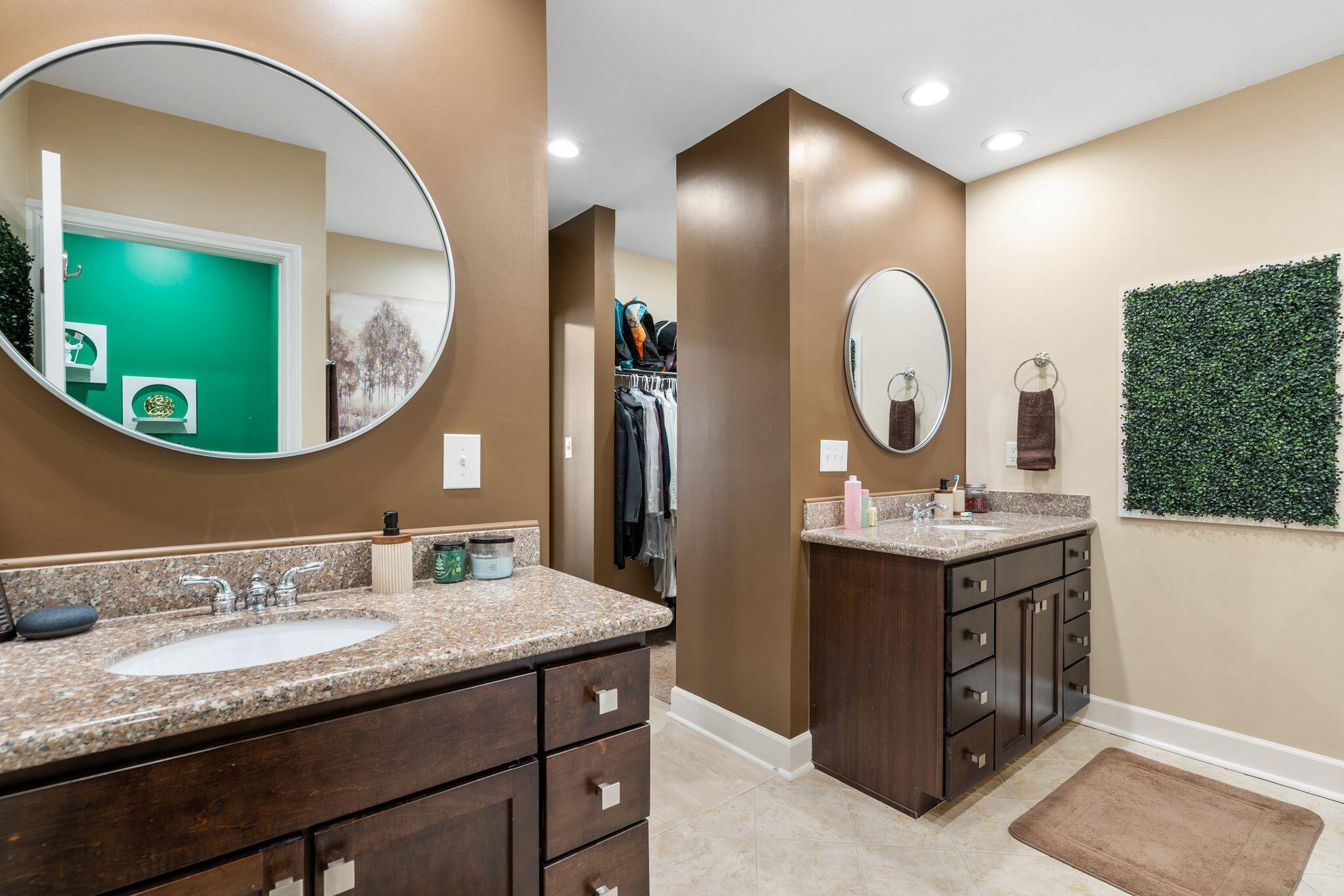 8700 Front Beach Road, Unit 6310 Panama City Beach, FL 32407 - Photo 26 of 42 a bathroom with a granite countertop double vanity sink and a mirror
