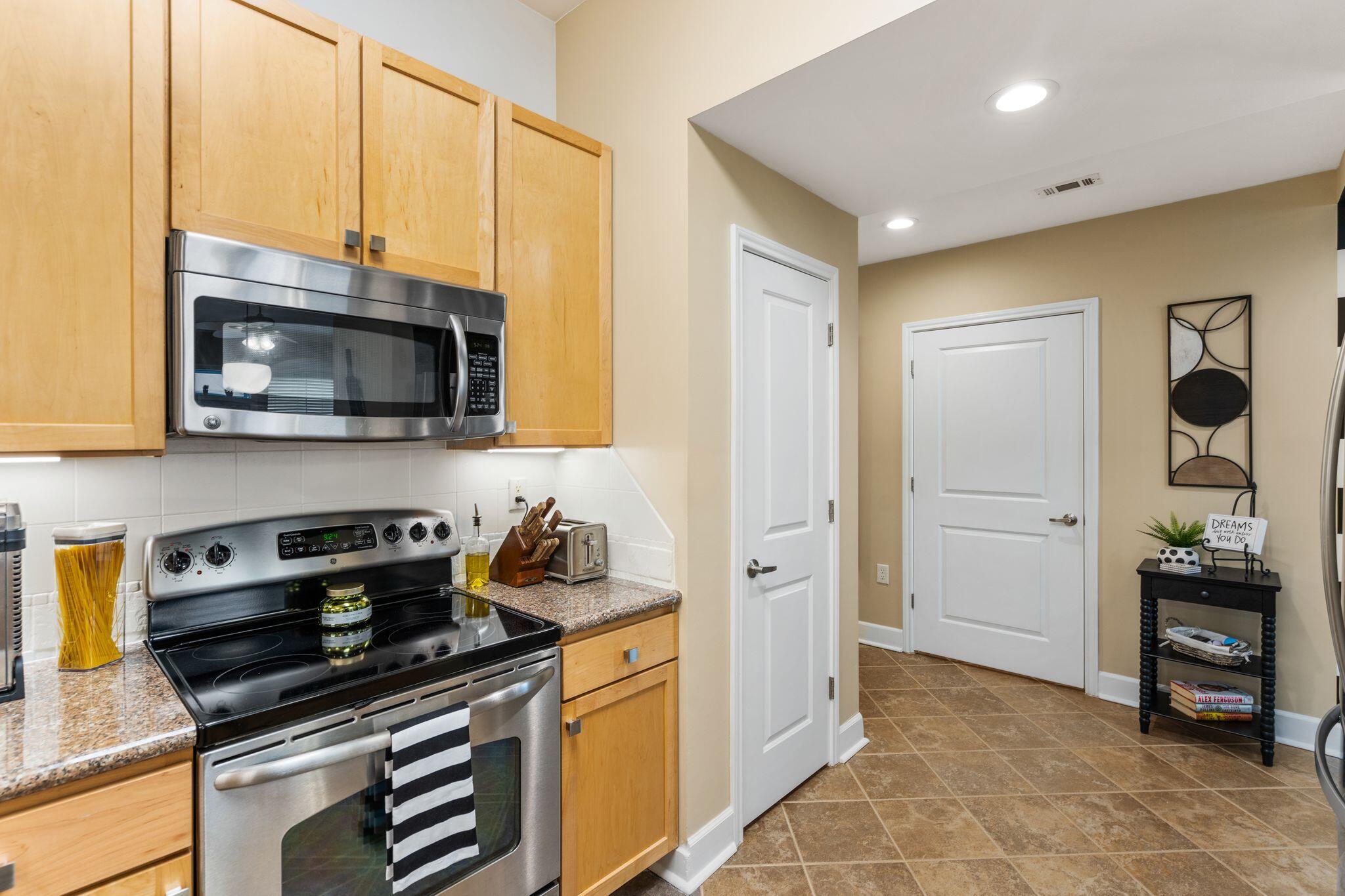 8700 Front Beach Road, Unit 6310 Panama City Beach, FL 32407 - Photo 5 of 42 a kitchen with stainless steel appliances a stove a microwave and cabinets