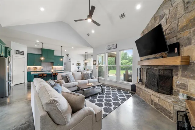 a living room with furniture a flat screen tv and a fireplace