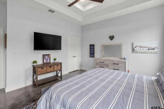 a bedroom with a bed and a flat screen tv