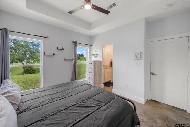 a bedroom with a bed and a large window