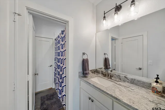 a bathroom with a double vanity sink and a mirror