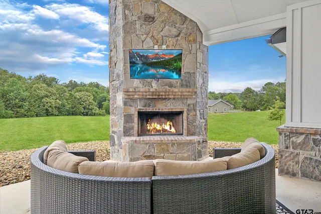 a living room with patio furniture and a fireplace