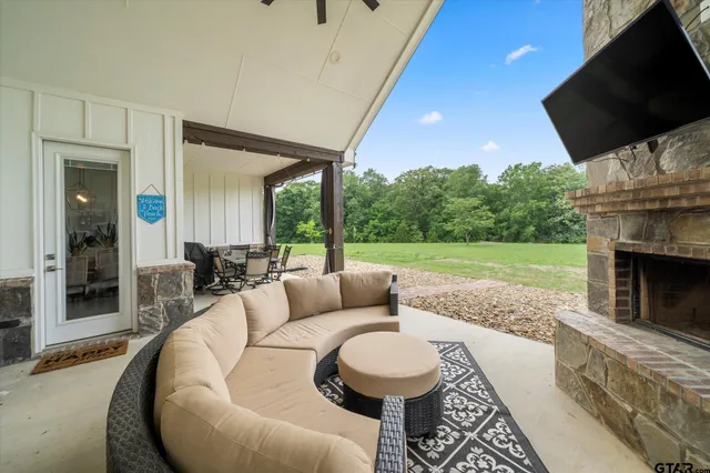 a living room with furniture a flat screen tv and a fireplace