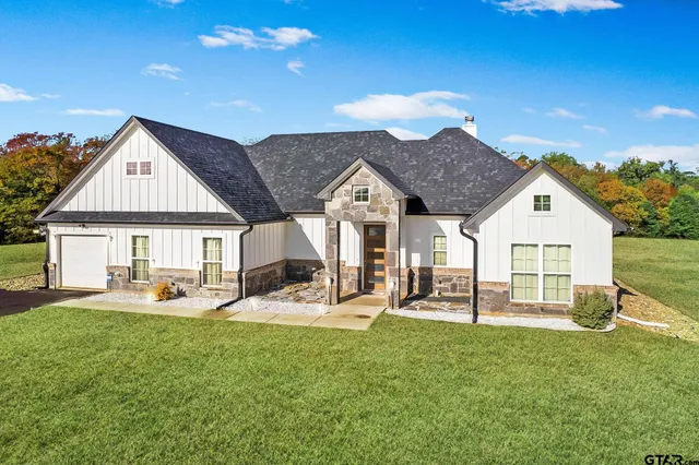 a front view of house with a garden and patio