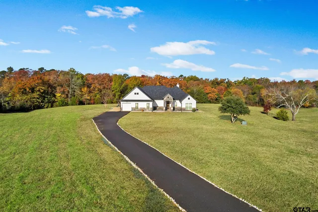 a view of a golf course with an ocean
