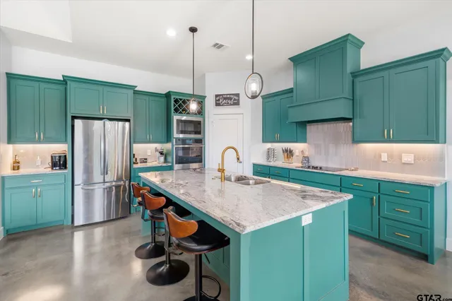 a kitchen with a refrigerator a sink and a cabinets