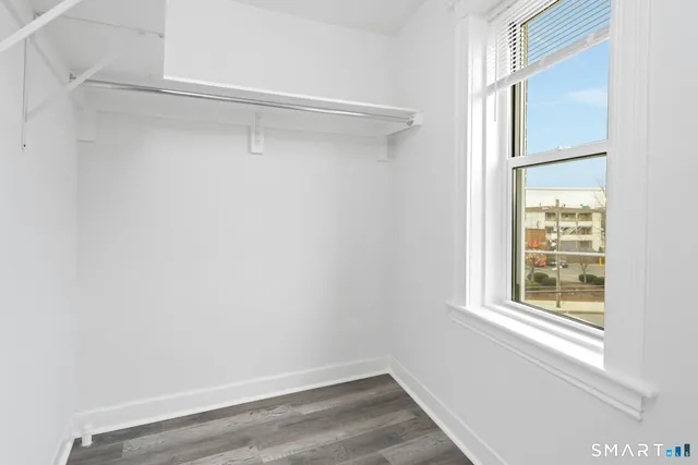 a view of a room with rack on the wall and a window