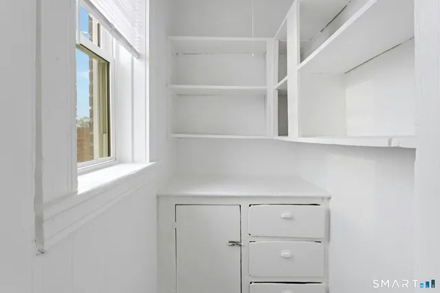 a view of a closet area with cabinets