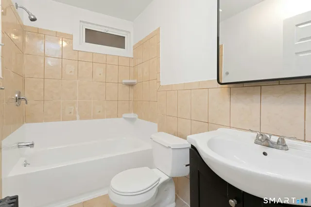 a bathroom with a sink a toilet and bathtub