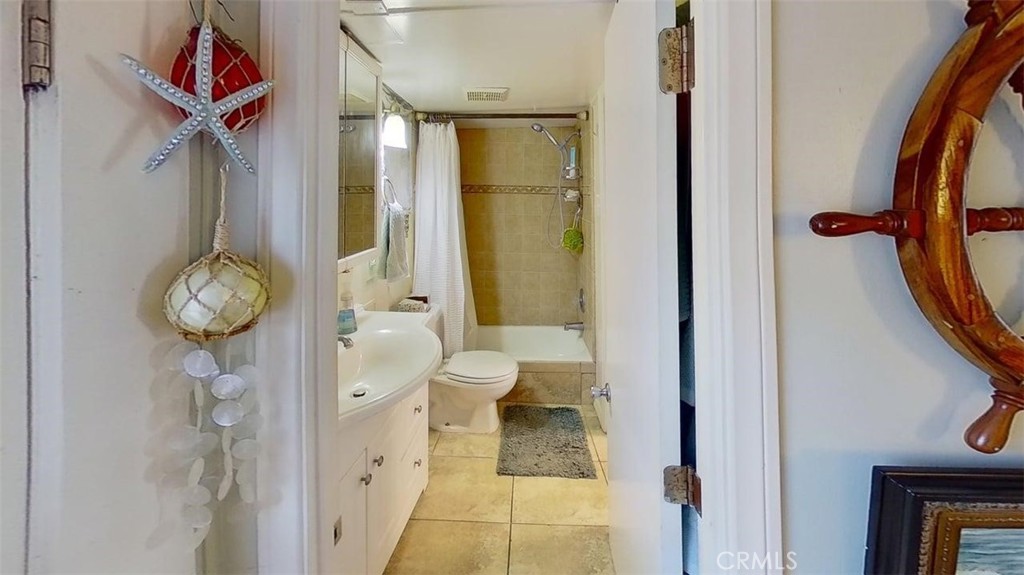 85 Riversea Road Seal Beach, CA 90740 - Photo 16 of 18 a bathroom with a toilet and a shower