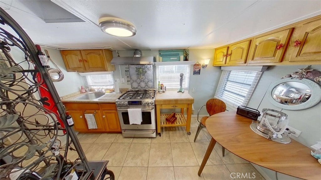85 Riversea Road Seal Beach, CA 90740 - Photo 7 of 18 a kitchen with stainless steel appliances kitchen island granite countertop a stove and a sink
