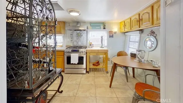 a kitchen with stainless steel appliances kitchen island granite countertop a stove and a sink