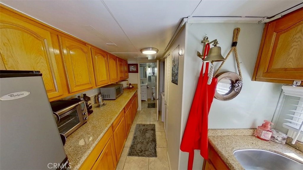 85 Riversea Road Seal Beach, CA 90740 - Photo 9 of 18 a view of walk in closet with clothes and shoes