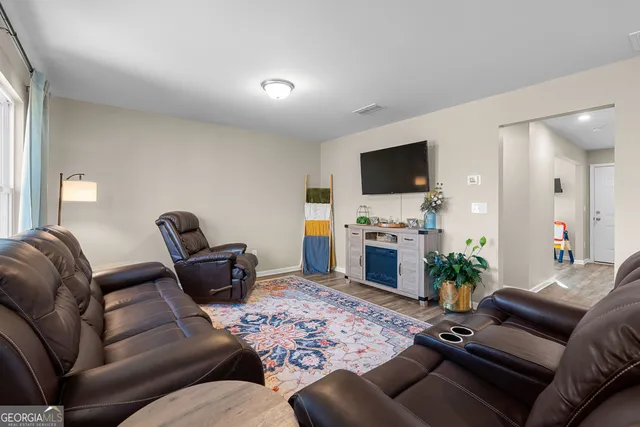 a large kitchen with a table and chairs