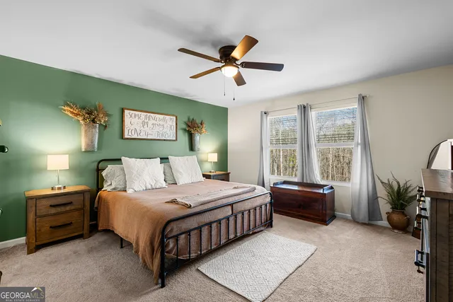 a bathroom with a granite countertop sink a toilet and shower