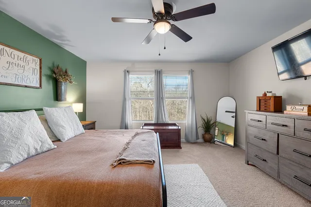 a view of walk in closet with clothes