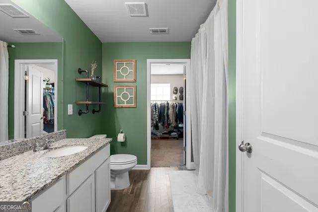 a bedroom with bed and wooden floor