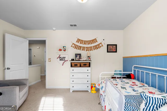 a bedroom with a bed and a flat tv screen