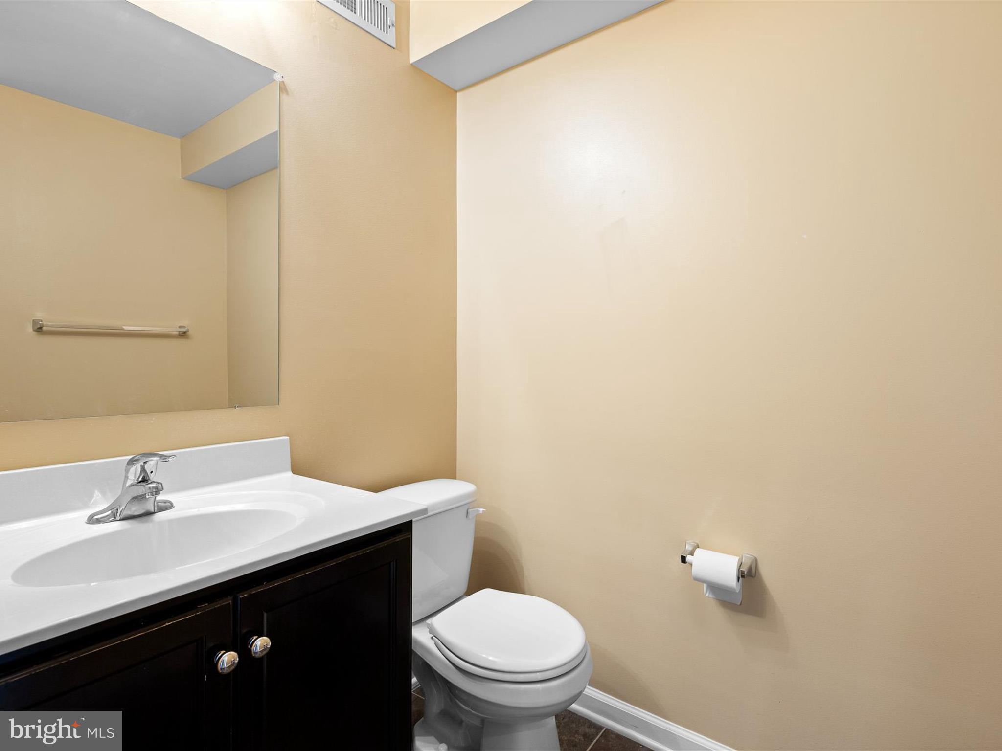 1092 Worth Lane, Unit BL12 Claymont, DE 19703 - Photo 13 of 20 a bathroom with a granite countertop sink a toilet and a mirror