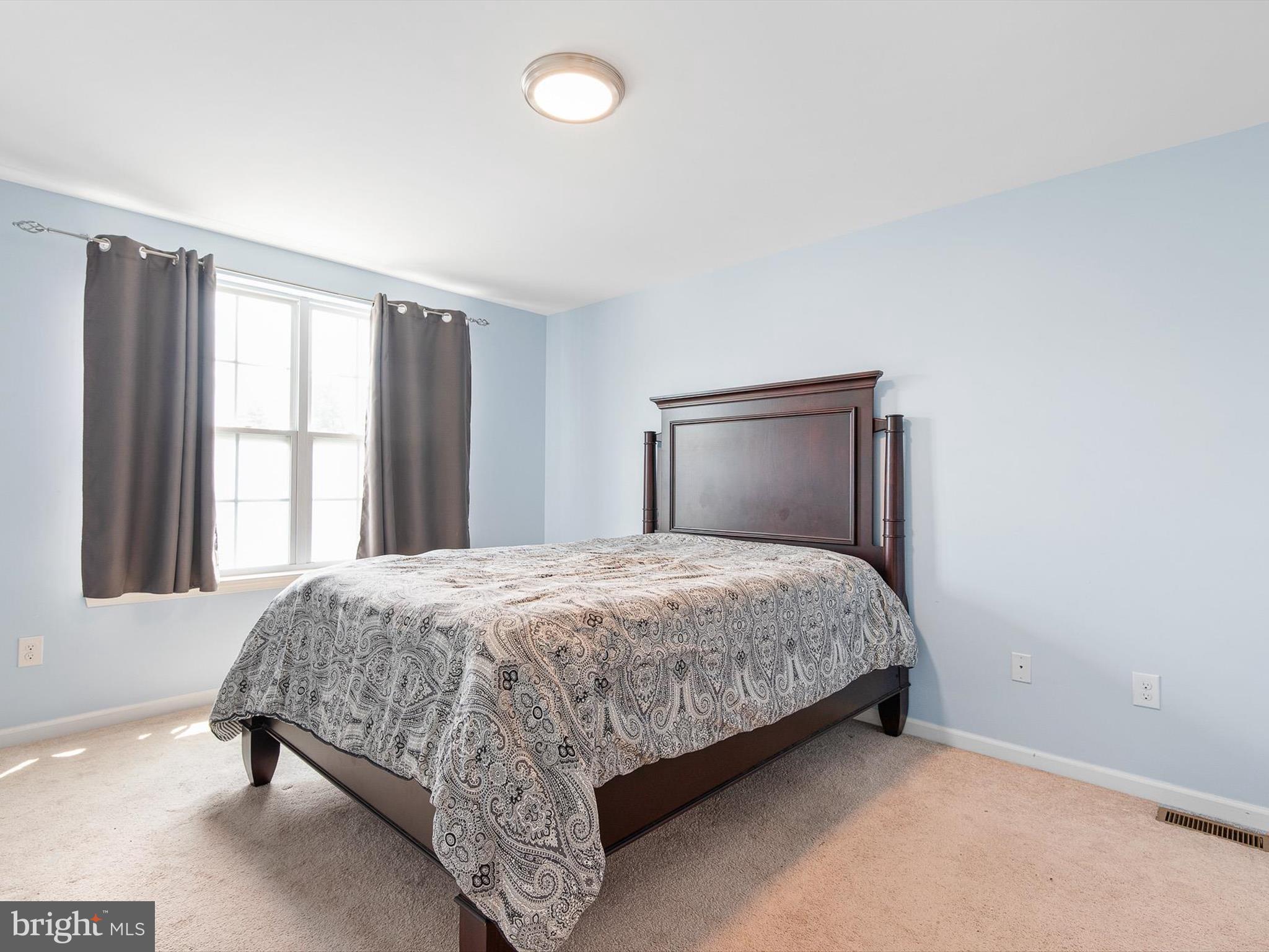 1092 Worth Lane, Unit BL12 Claymont, DE 19703 - Photo 18 of 20 a bedroom with a bed and a window