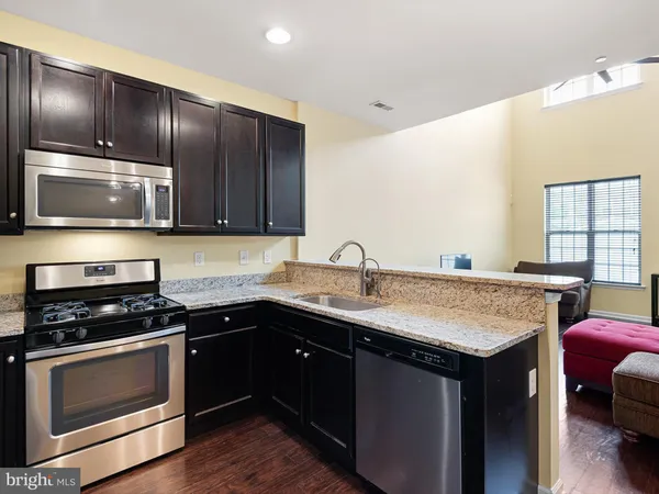 a kitchen with a sink stove and microwave