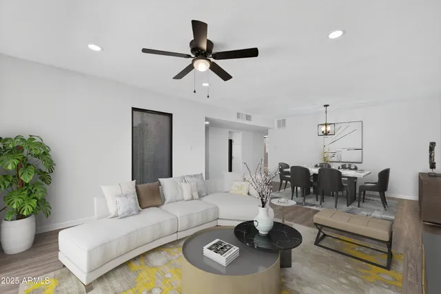 a living room with furniture and a potted plant