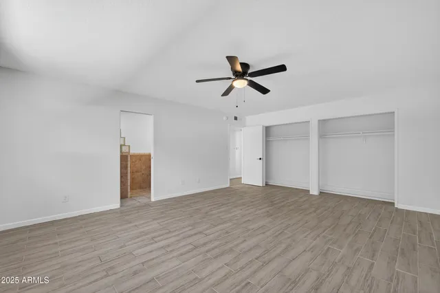 a view of empty room with wooden floor