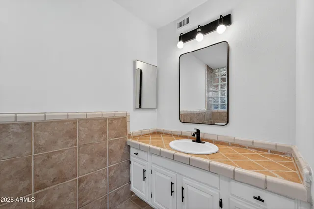 a bathroom with a sink and a mirror
