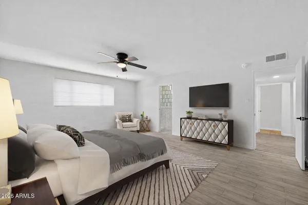 a view of a livingroom with furniture wooden floor windows and a chandelier