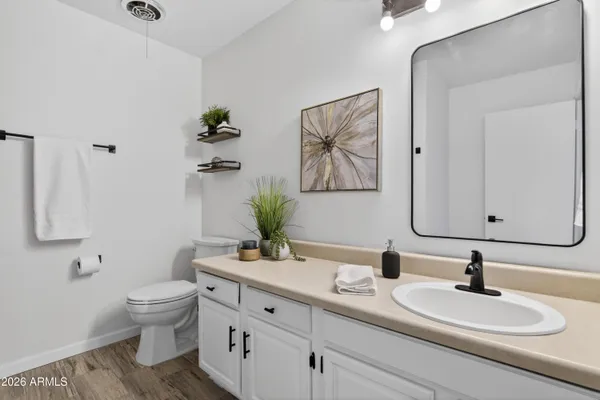 a view of empty room with wooden floor and ceiling fan