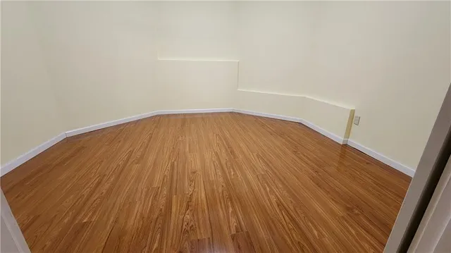 a view of wooden floor in a hallway