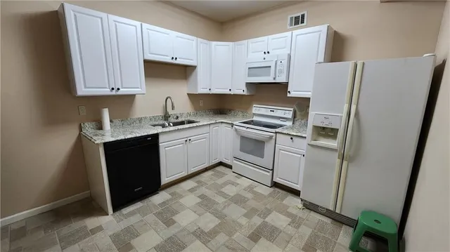 a kitchen with stainless steel appliances a stove sink and refrigerator