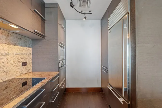 a bathroom with a tub shower and sink