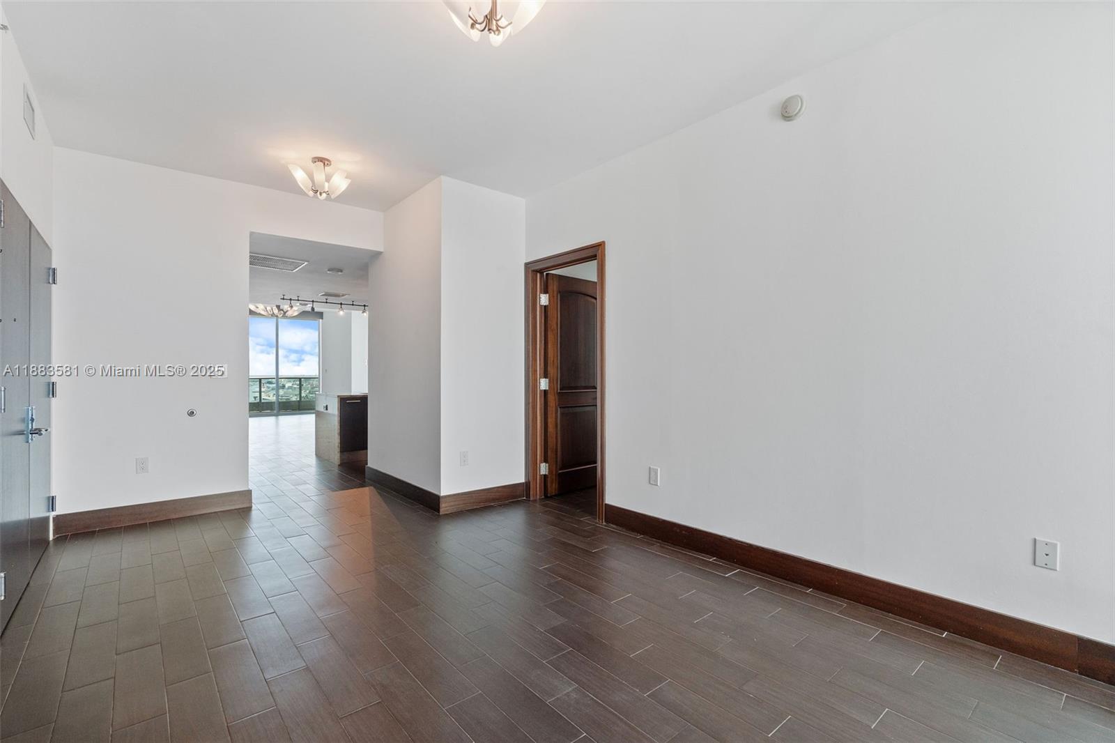 900 Biscayne Boulevard, Unit 3502 Miami, FL 33132 - Photo 26 of 42 an empty room with wooden floor and a window