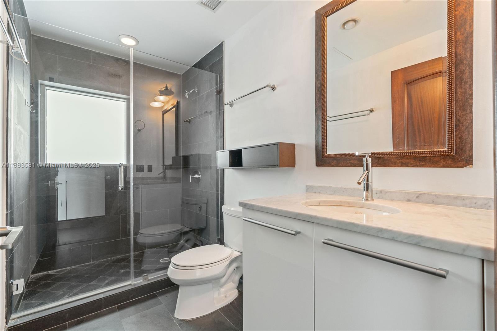 900 Biscayne Boulevard, Unit 3502 Miami, FL 33132 - Photo 35 of 42 a bathroom with a sink a toilet and shower