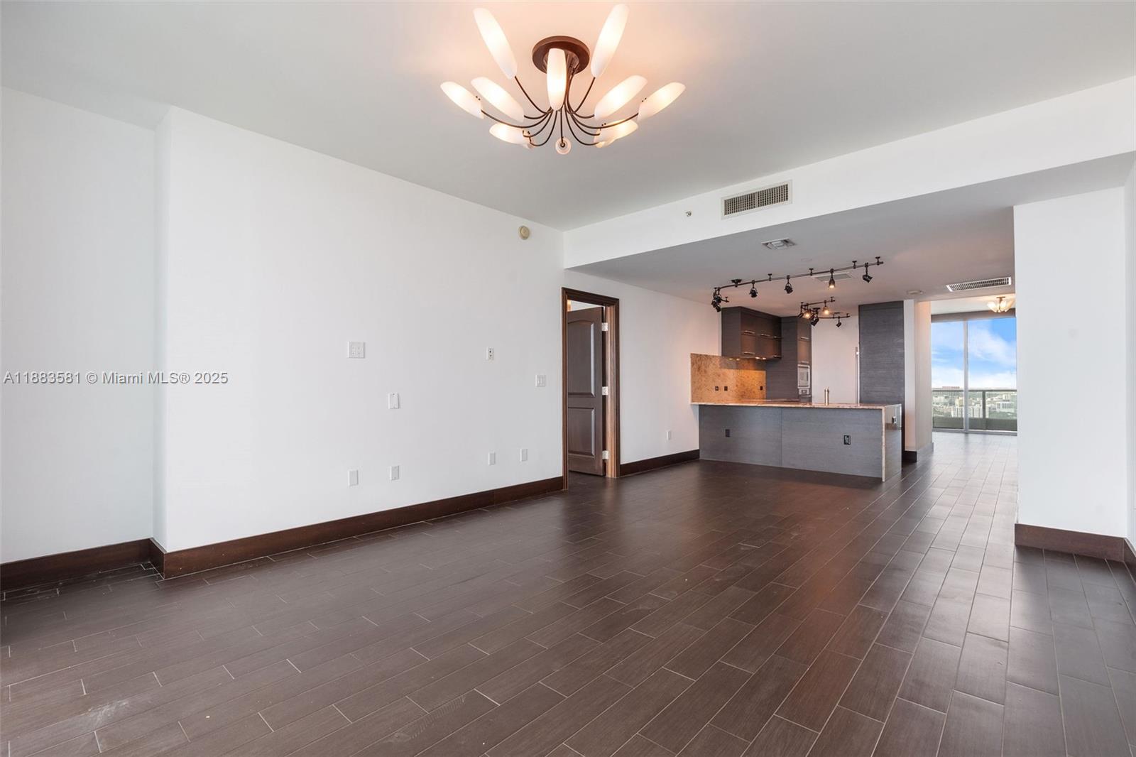 900 Biscayne Boulevard, Unit 3502 Miami, FL 33132 - Photo 9 of 42 a view of empty room with wooden floor and a window