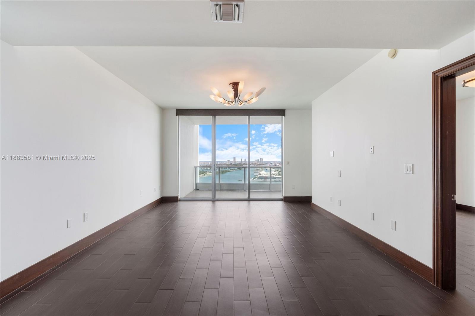 900 Biscayne Boulevard, Unit 3502 Miami, FL 33132 - Photo 10 of 42 an empty room with wooden floor and a window