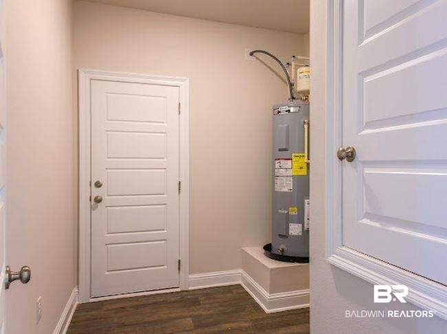 13791 Logan Place Foley, AL 36535 - Photo 24 of 25 Wood-finish flooring with white baseboards and a paneled white door with round door handles